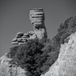 7.5 - I like the layers of contrasting black and white created by the central vegetation. To me the image is sharp and properly exposed. I do think the vignette is a bit too strong. I think the overall impact would be enhanced by cropping in from the right to lower the vegetation below the height of the hoodoo. I think that would emphasize the rock formation better. The subject is the hoodoo so anything that distracts from the subject (like the road sign) needs to be delt with in post. I think cropping up from the bottom to eliminate the horizon line would kill two birds with one stone. I like the multiple layers of texture that is complimented by the texture of the vegetation. Maybe a curves adjustment to add just a bit more contrast would really make this hoodoo pop.