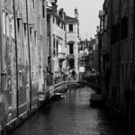 8.0 - A visual presentation of the canal environment of many costal cities in Europe. I like how my eyes are drawn into the image by the sunny side of the canal. I like having someone on the bridge to add scale to the buildings. Foe me, the right side shadows are too dark and hide the leading lines on that side of the image.Maybe a linear gradient in Lightroom masking could gradually reduce some of the shadows and add a bit more drama. To my eyes, the focus seems a little soft. There is nice contrast on the sunny side of the canal. To me, a darker sky would help direct my eyes to the center of the image.