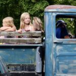 6.0 - The image is more a snapshot of the vehicle with some children. It would be more impactful if at least one of the people, the driver or one of the children is looking at the camera.