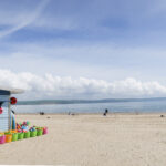 7.0 - Nice colourful shop at the beach. The image can be cropped tighter to bring focus to the shop and the colours.