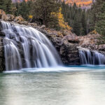 1st - 6.0 - Absolutely beautiful waterfalls! I believe this is a lovelycomposition, well-cropped and positioned. The touch of color along theupper edge gives a sense of time and place to the image. It appears tome the rocks and background trees lack detail. A smaller aperturewould provide a greater depth of field and, thus, more detail; or maybetune down the detail slider. Some may think the very blue water wouldbe better represented more green, like the surrounding water; certainlya personal preference. A very lovely image.