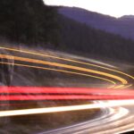 7.0 - There is no doubt—this image is a long exposure. The curve of thelights makes a nice compositional element. I am guessing one big trailertruck coming up that mountain. The focus on the background is soft. Asharp focus on the background would really make the trailing lightspop. The highway has some hot spots which draw my attention fromthe trailing lights. I would try to tone down the haze on the backgroundmountains. A well-composed image.