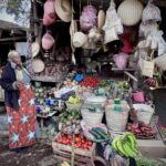 6.0 - Shopkeeper in Africa showing her wares is well composed; busy photo but meets category well