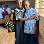 1st - 10,0 - Heartwarming photo of caring girls in Africa; very sharp, well composed; background soft; front sharp.