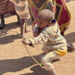 2nd - 8.0 - Nice human interest image. I wish this had been taken from a ground level look at the boy.