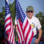 8.5 - Very colorful patriotic image. A bit of mystery is provided by the soldier half hidden by the flag and who is hiding his identify with the low slung hat and sunglasses. Good use of DoF, lighting and exposure. Nicely done.