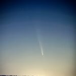 7.5 - Nice action capture. To enhance the image, I would recommend darkening the sky a bit more, especially the lower part between the comet and the land. More interest might be had by cropping the image on both sides a bit to reduce the large amount of negative space.