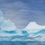 8.0 - Burr! The maker has deftly captured the beautiful of a large ice berg and its trademark blue color. Very nice technicals. If possible, re-crop to give the right side a little more space.