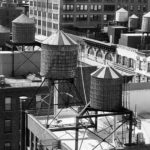 2nd - 8.5 Apply titled image. The maker has positioned his camera to capture three similar roof tops which not only backs up the chosen title, but also the smaller two similar roof tops complement the main subject area nicely. A bit more contrast of the three larger water containers would make them stand out more and better identify them as the main subject, as well as adding overall appeal to the image.